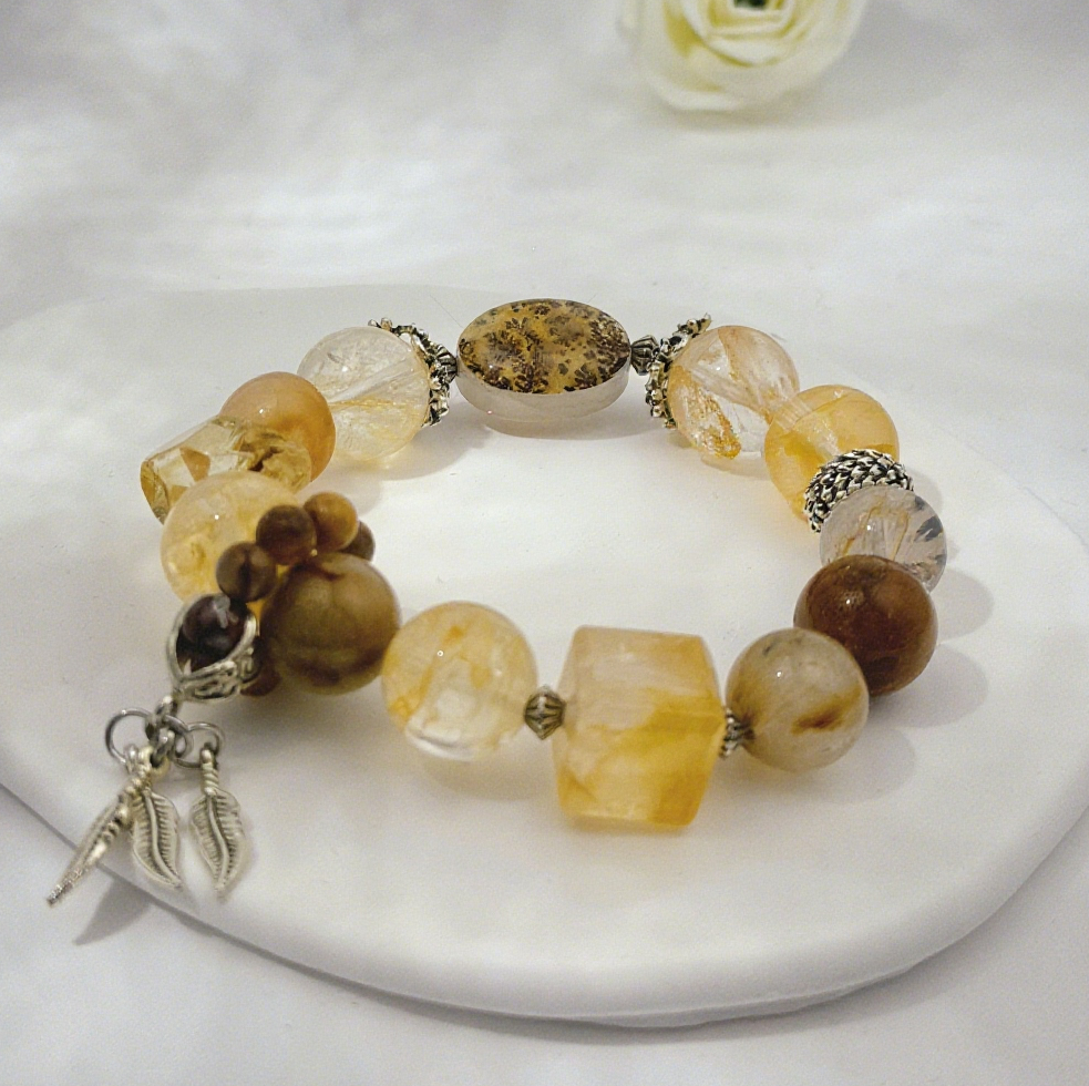 This Golden Aura Leaf Whisper Bracelet strings the golden-aura shine of yellow rutilated quartz and the grass-flower secret realm of garden phantom quartz into a natural whisper on the wrist.